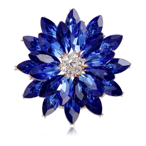 Detailed view of luxury flower brooch with blue crystal petals and sparkling white rhinestones