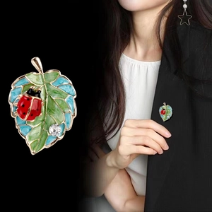 Exquisite enamel ladybug and green leaf brooch with gold plating and sparkling crystal