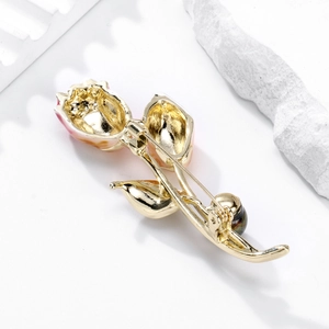 Elegant vintage rose flower brooch in gold with pink enamel petals on white stone