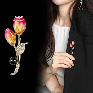 Elegant tulip brooch with pink enamel petals, crystal leaves, and a black pearl drop