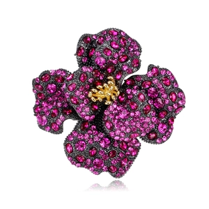 Macro shot of luxury peony flower brooch with magenta gemstones and gold stamens