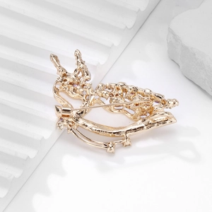 Elegant gold butterfly brooch with purple stones back view on white display stand