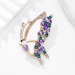 Elegant butterfly brooch with purple and green crystals and pearl on gold base