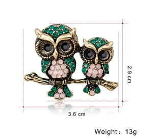 Detailed view of vintage owl brooch with green crystals and 3.6cm size measurements