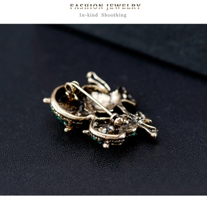 Detailed back view of vintage owl brooch showing the secure safety pin clasp mechanism