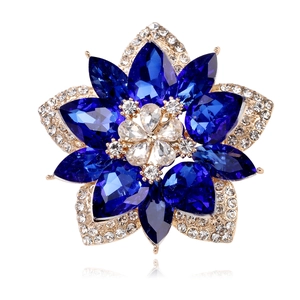 Detailed macro view of the blue crystal flower brooch with gold plating and white zircons