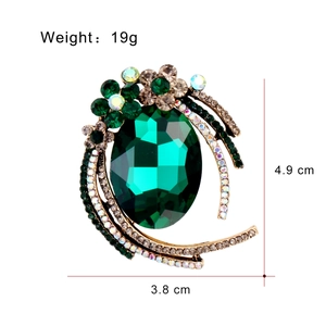 Elegant vintage alloy brooch with large green oval gemstone and white crystal accents