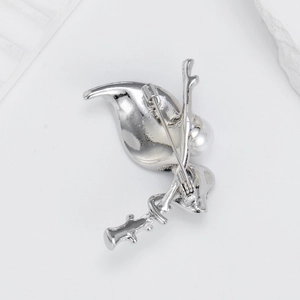 Silver leaf brooch with white pearl featuring a secure safety pin closure on the back