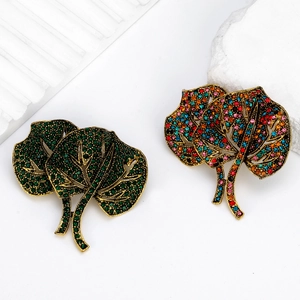 Vintage leaf brooch set with emerald green and colorful rhinestones in antique gold finish