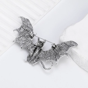 Vintage bat-shaped flying cat brooch in retro silver finish with detailed wing textures