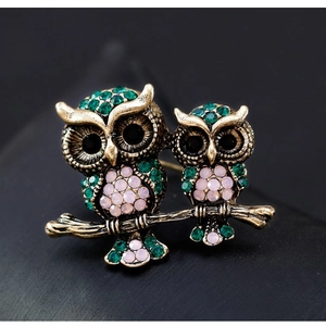 Retro gold owl brooch featuring green rhinestones on branch for a vintage look