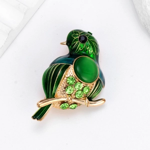 Élégante broche oiseau en émail vert avec pierre œil-de-chat et strass sur métal doré