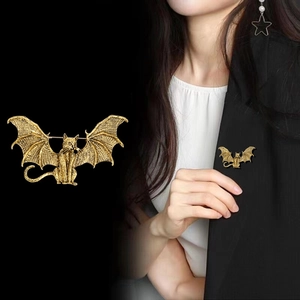 Vintage gold bat cat brooch featuring detailed wing texture and gothic aesthetic style