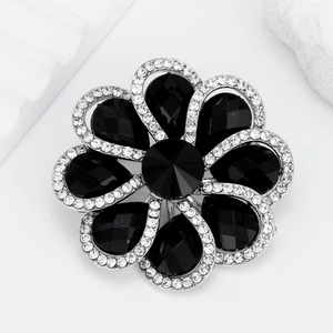 Elegant silver flower brooch with black gemstones and sparkling white rhinestones