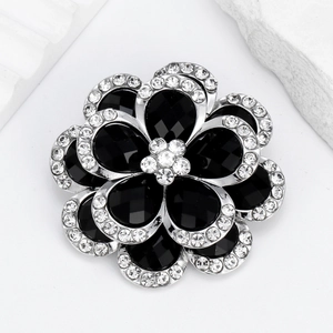Elegant black flower brooch with silver metal petals and sparkling crystal rhinestones