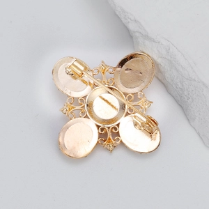 Back view of a gold baroque rhinestone brooch with a secure clasp and vintage design