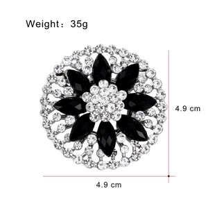 Elegant floral disc brooch with black marquise gems and white rhinestones on silver base