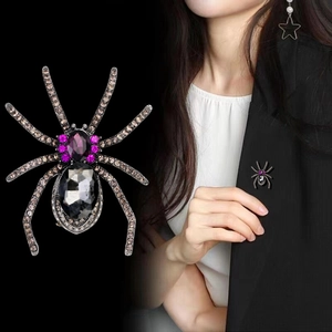 Creative spider brooch with purple crystals and vintage silver alloy on black background