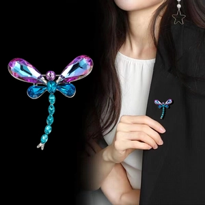 Colorful crystal dragonfly brooch for suit jackets with gradient wings on black background