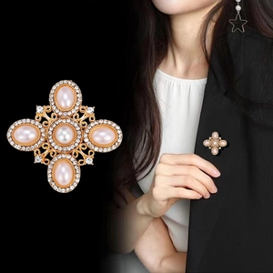 Baroque crystal cross brooch with pink pearls for women shown on model and close-up