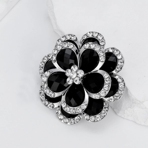 Elegant silver-tone flower brooch with black faceted petals and sparkling white rhinestones