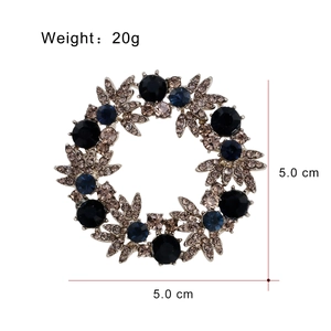 Elegant floral wreath brooch with dark blue stones and champagne crystals on white base