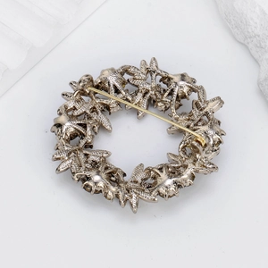 Elegant starfish wreath brooch with silver metal base and gold pin closure back view