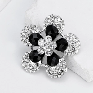 Elegant floral brooch with black teardrop gems and white crystals on silver base