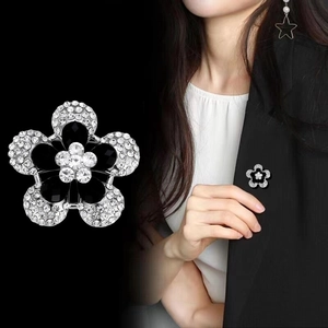 Elegant five-petal flower brooch with black gemstones and white crystals on silver alloy