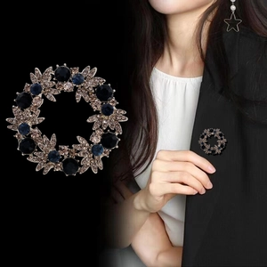 Vintage wreath brooch with black and champagne crystals on dark alloy base for suits