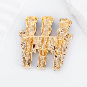 Back view of gold-plated nutcracker brooch showing sturdy pin clasp and metal finish