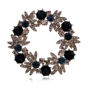 Elegant silver wreath brooch with sparkling blue and smoky brown rhinestone crystals
