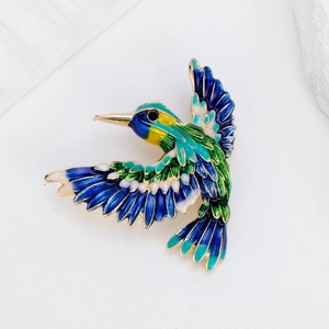 Vibrant enamel kingbird brooch in blue and green with gold alloy details and fine textures