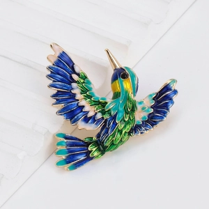 Exquisite hummingbird brooch with vibrant blue and green enamel in a flying pose