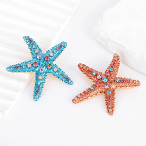 Elegant rhinestone starfish brooches in blue and rose gold with colorful crystal accents
