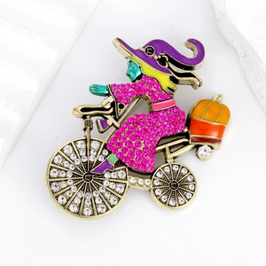 Colorful Halloween witch riding bicycle brooch with rhinestones and enamel details