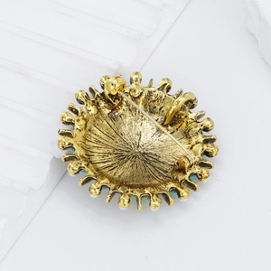 Vintage Bohemian golden round brooch with pearl accents shown from a rear functional angle