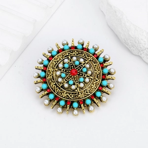 Bohemian vintage round brooch with red faceted stone and pearls in sunburst design