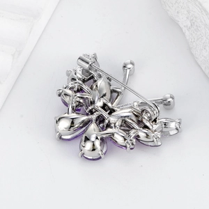 Silver-toned crystal butterfly brooch back view showing pin clasp and purple gemstones