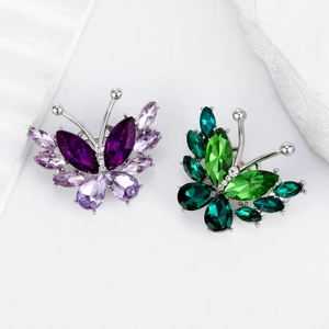 Elegant crystal butterfly brooches in purple and green hues with silver metal base