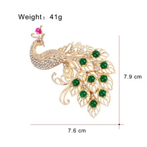Sparkling peacock brooch in gold alloy with green rhinestones, 7.9cm x 7.6cm size