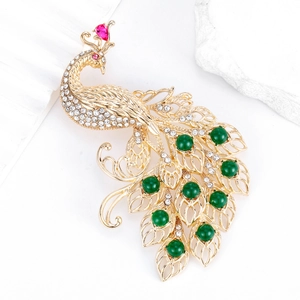 Exquisite gold peacock brooch with sparkling white rhinestones and green gems for women