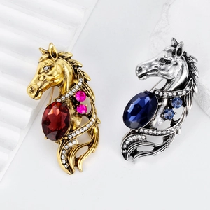Retro horse head brooch set in gold with red stones and silver with blue crystals