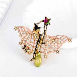 Halloween bat brooch with witch hat and spider elements on a polished gold base