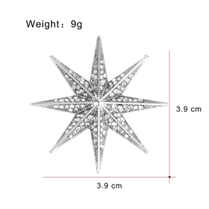 Octagon star brooch in silver finish with pavé rhinestones measuring 3.9cm by 3.9cm