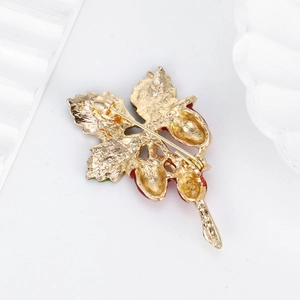 Elegant gold strawberry leaf brooch showing detailed back view with safe pin clasp