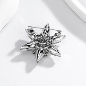 Elegant silver snowflake brooch with glass rhinestones and secure safety pin back