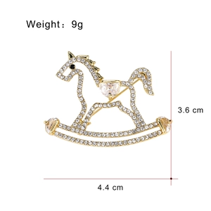 Elegant gold horse brooch with sparkling white rhinestones and heart shaped crystals