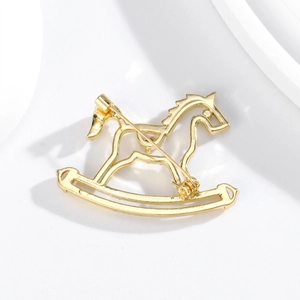 Minimalist gold rocking horse brooch in hollow metal design for men and women