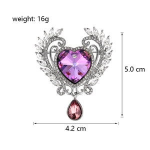 Angel wings heart brooch with purple crystal and teardrop pendant on white background